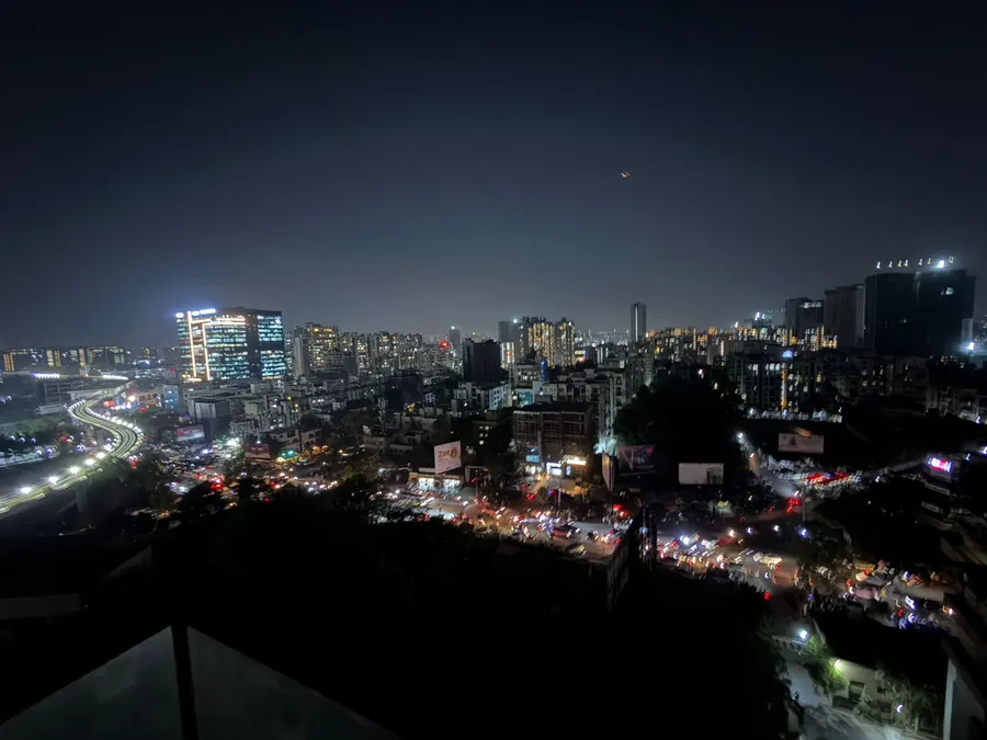 Pune at night from above, traffic light trails running through the city