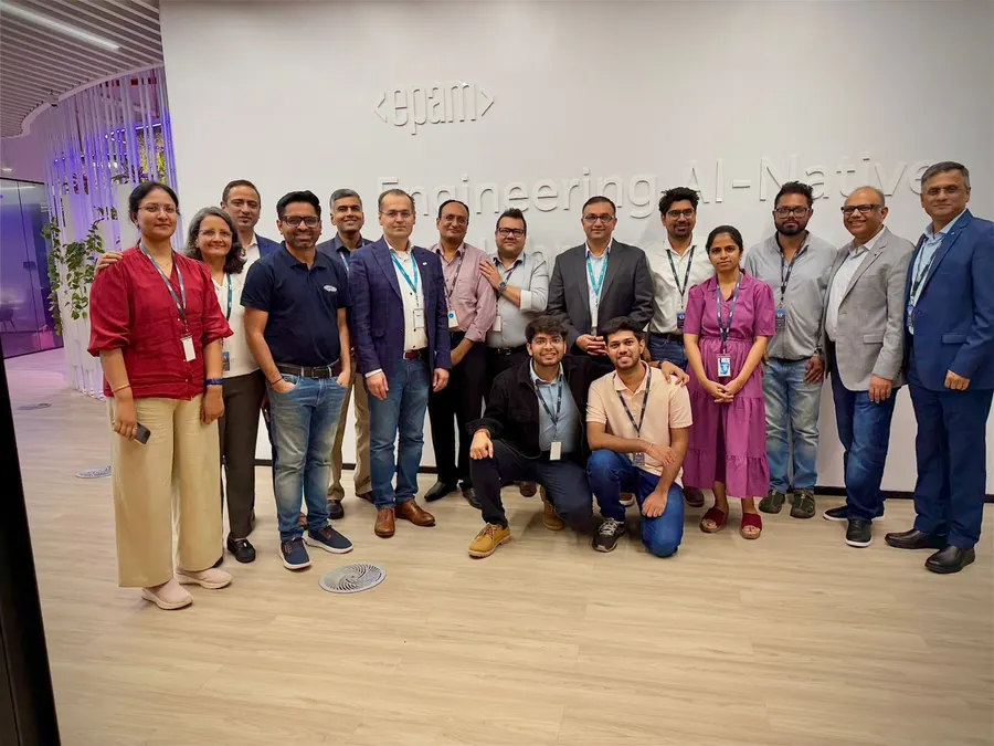 The EPAM Pune team standing in front of an 'Engineering AI-Native' wall