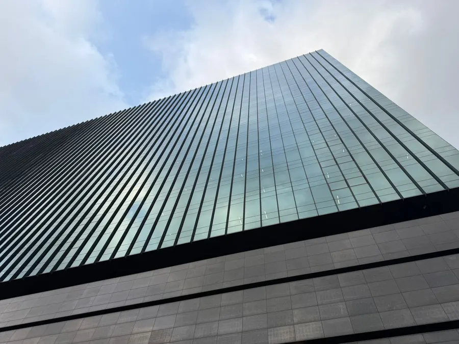 Looking straight up the glass facade of an office tower